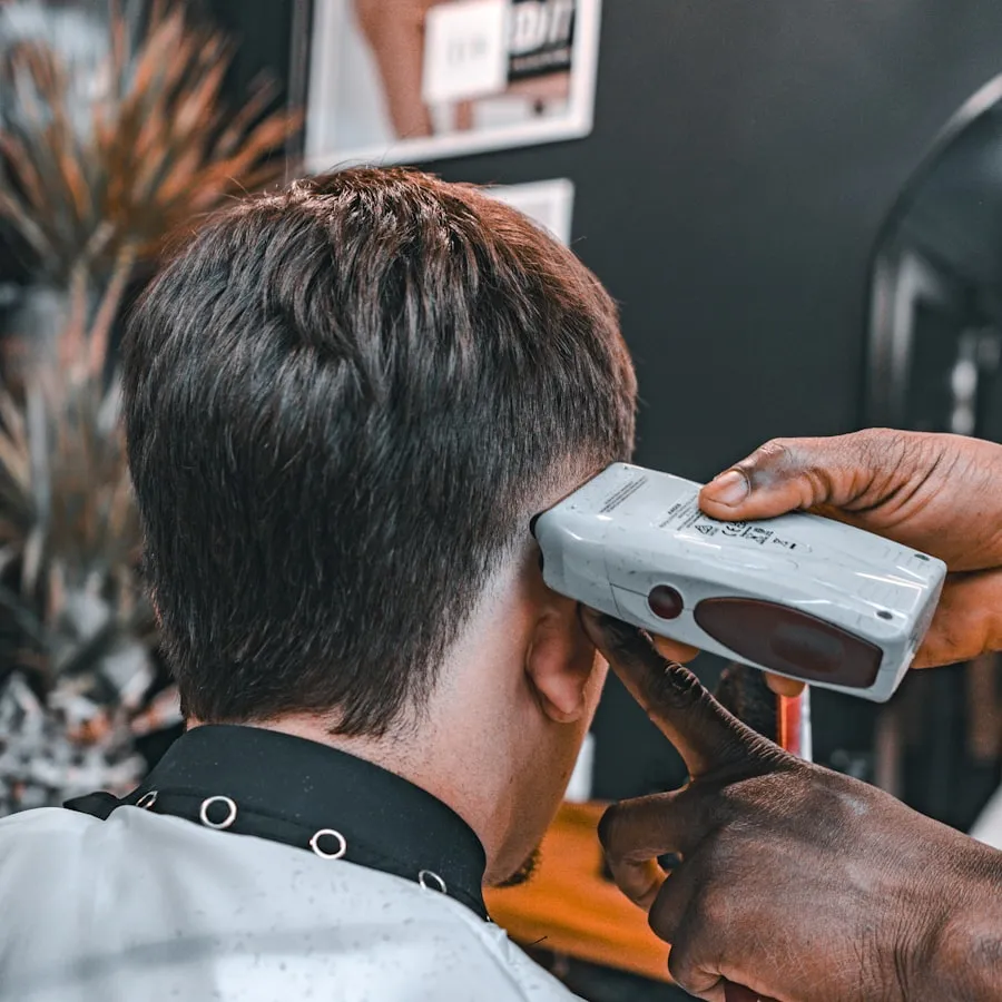 Dez Okonkwo working at his chair at Ironwood Barber Co.