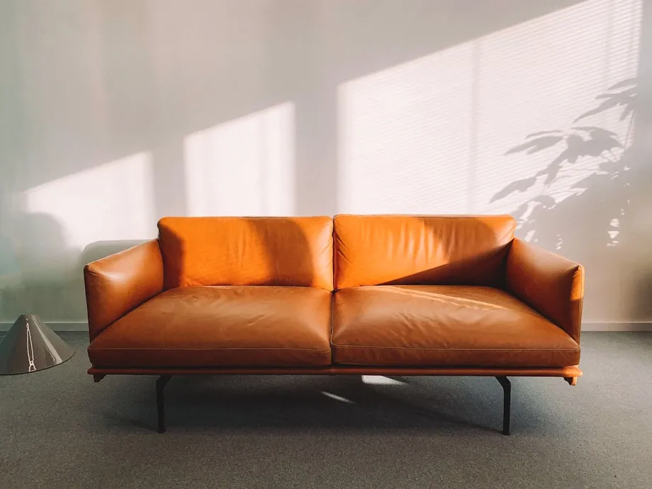 A furniture showroom floor with sofas arranged in staged room settings
