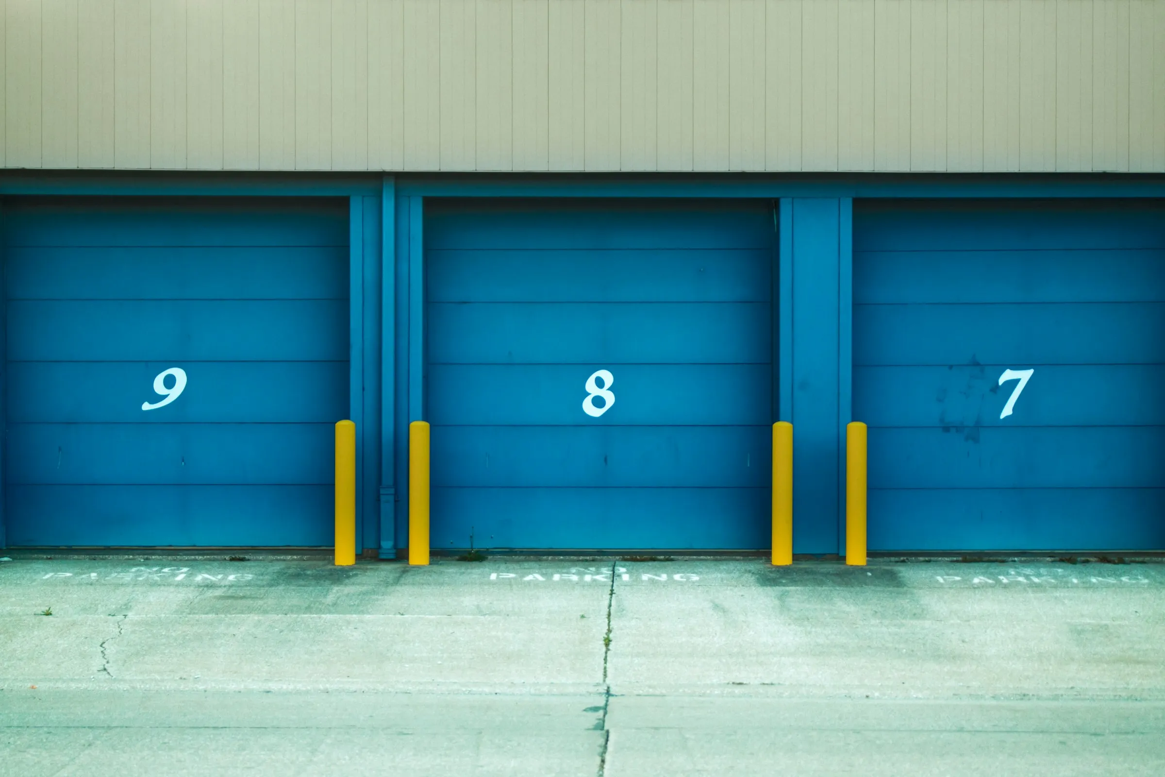 The six bays at Redline Auto Service with the doors up and cars on the hoists