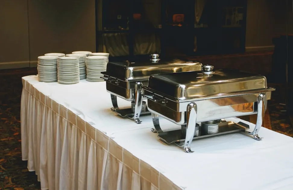 The pass at Saffron Table with catering trays being filled