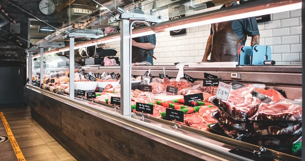 The butcher counter at Cedarview with a butcher working behind the case