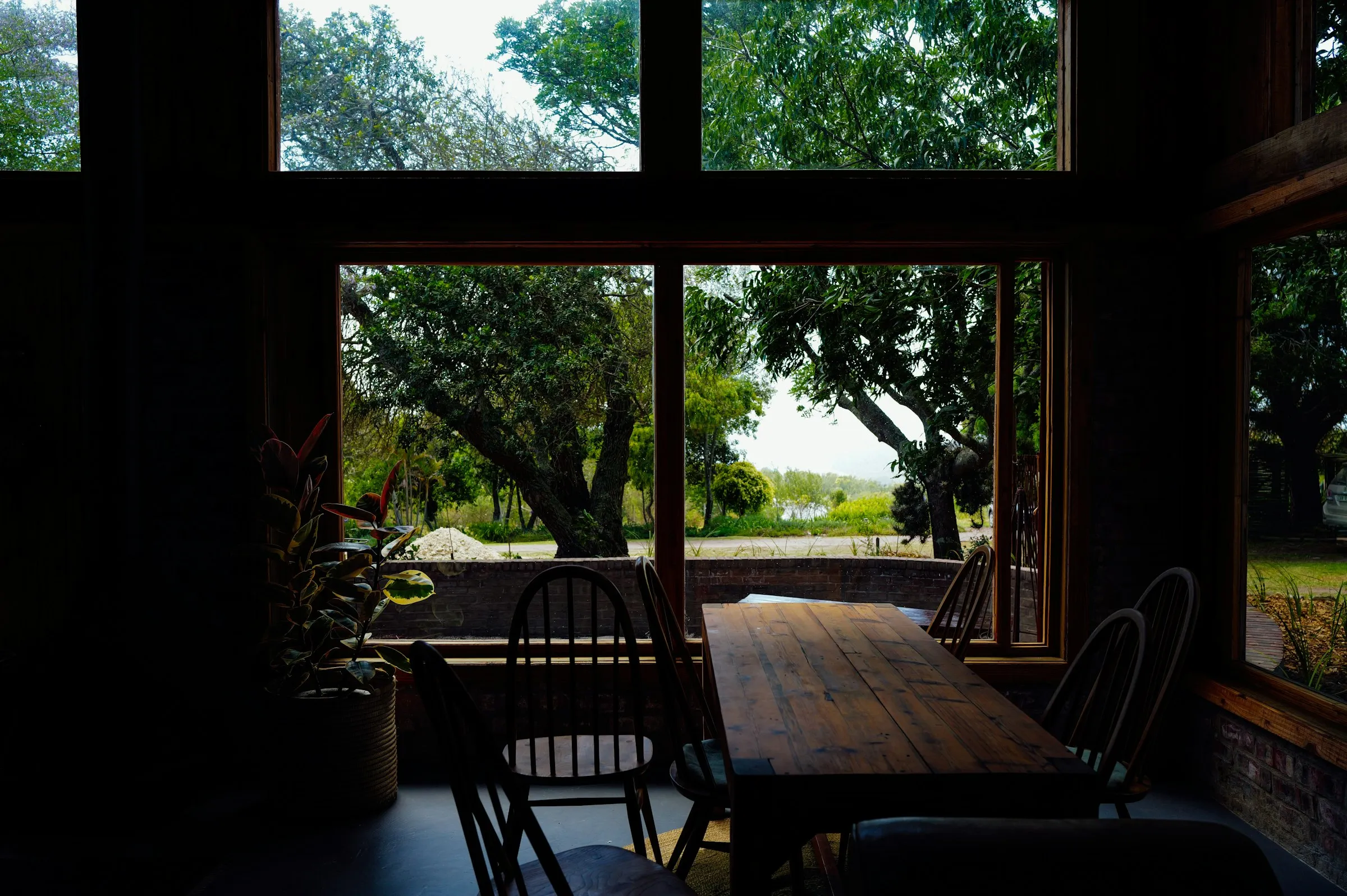 The Harbourview dining room at dusk with the lake visible through the windows