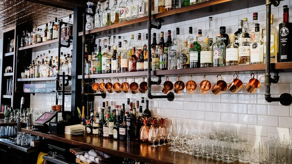 The bar side of Harbourview with guests along the rail and the tap wall lit behind