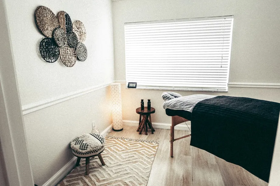 A made-up treatment room in a spa with fresh linen and low lighting