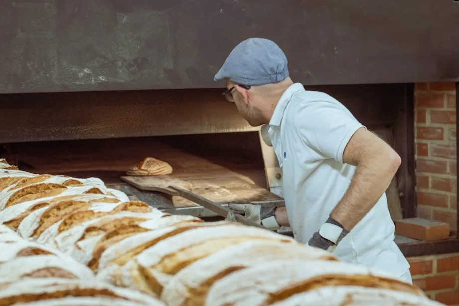 Racks of bread in trays waiting by the loading door of a wholesale bakery